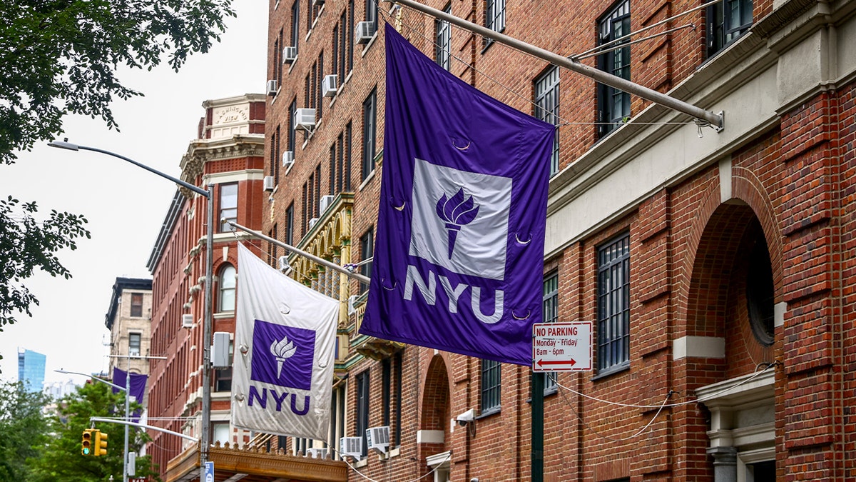 View of university buildings and street activity in Greenwich Village on a summer day.