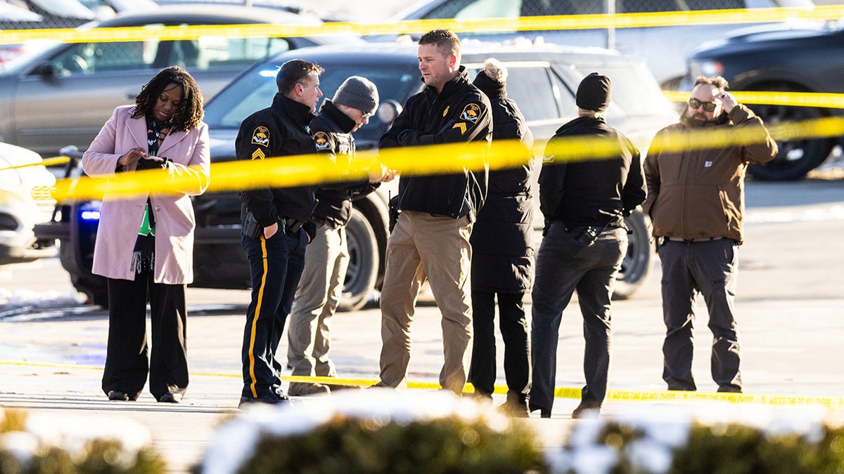 Police officers stand behind crime scene tape at scene of shooting in Omaha, Nebraska