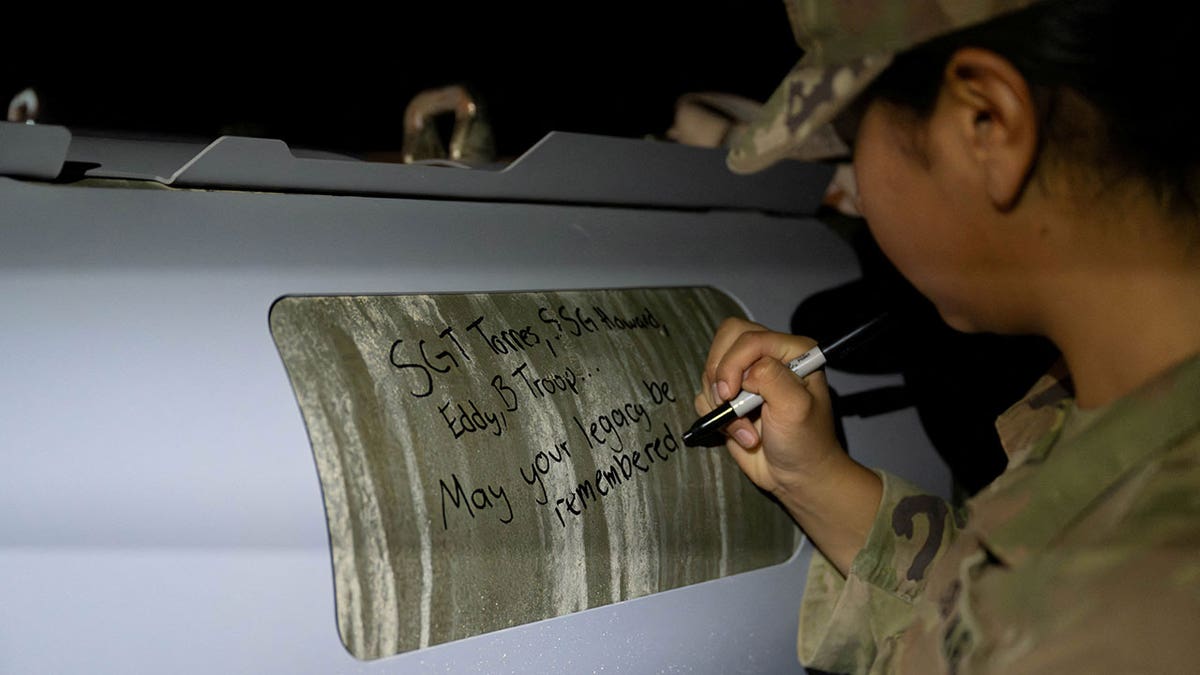 U.S. soldiers attached to the Iowa National Guard sign GBU-31 munitions systems in the U.S.