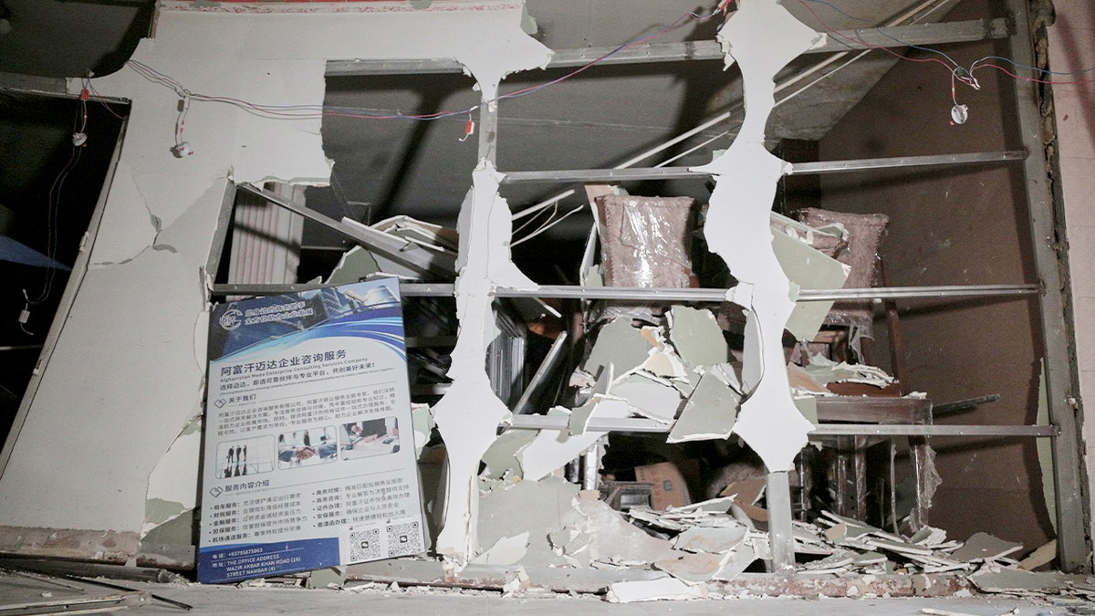 Damaged dining area with debris inside a restaurant following a deadly blast.