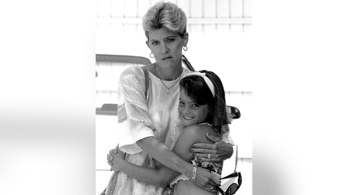 Mary Jo Buttafuoco holding onto her smiling daughter.