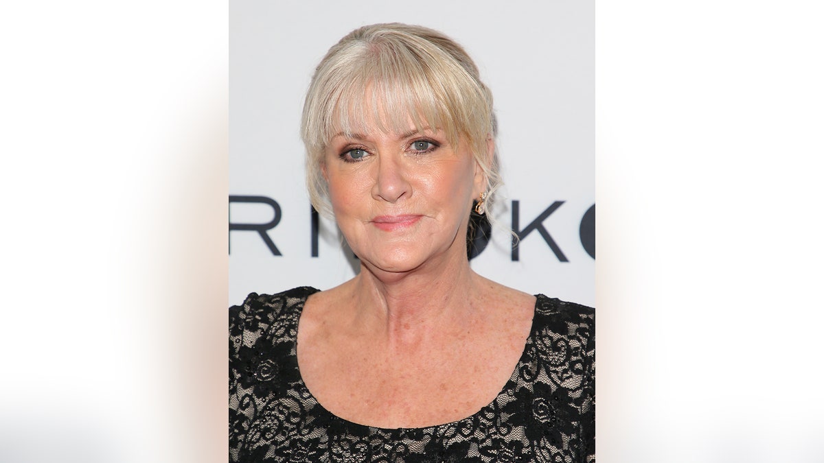 A close-up of Mary Jo Buttafuoco wearing a black lace dress.