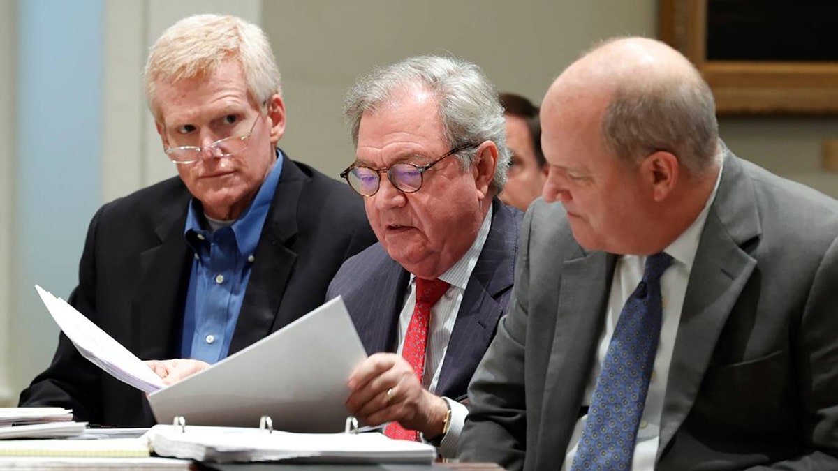 Alex Murdaugh sits in the Colleton County Courthouse with his legal team including Dick Harpootlian, middle, and Jim Griffin, right, as his attorneys discuss motions in front of Judge Clifton Newman in a December hearing