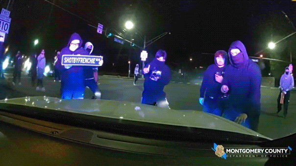 Wild video shows masked ruffians attacking police cruiser with officer inside during illegal street takeover Wild video shows masked ruffians attacking police cruiser with officer inside during illegal street takeover