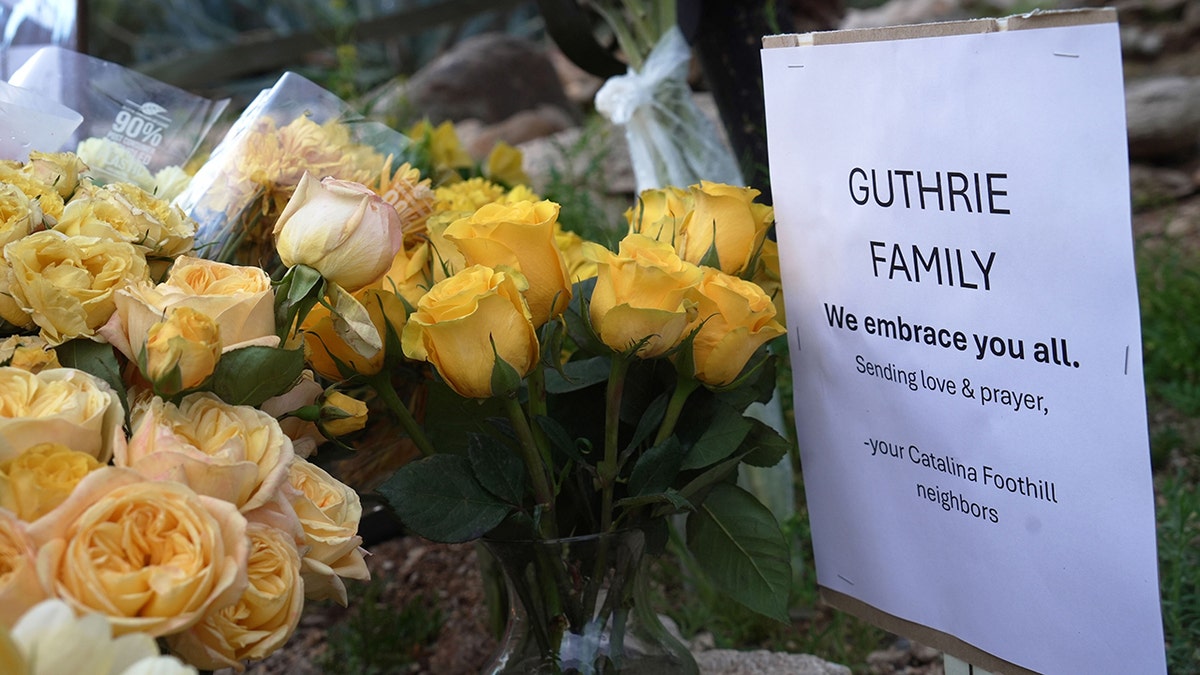 Nancy Guthrie's home with a growing vigil of flowers and candles in the morning light.