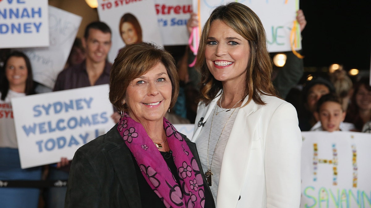 Savannah Guthrie and Nancy Guthrie posing together on an outdoor set with the Sydney Opera House in the background.