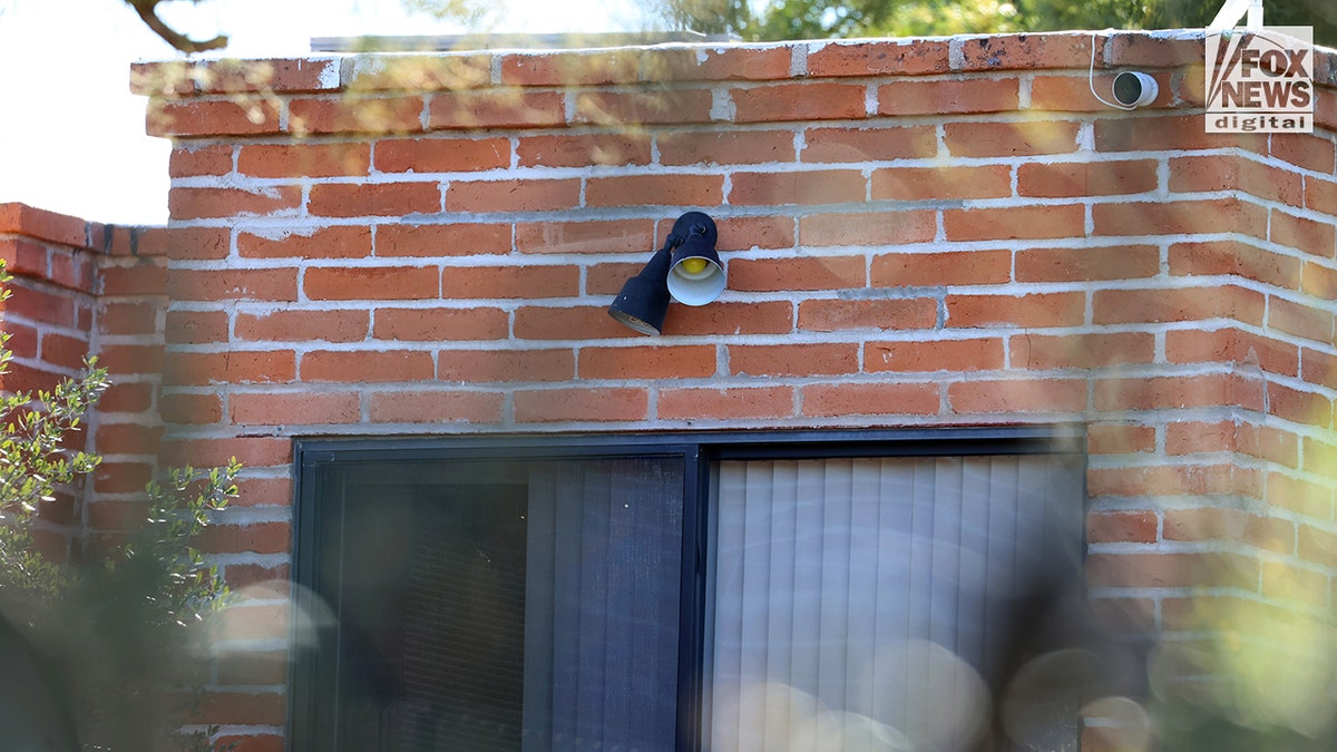 A close-up view of a floodlight mounted on the exterior of Nancy Guthrie’s home