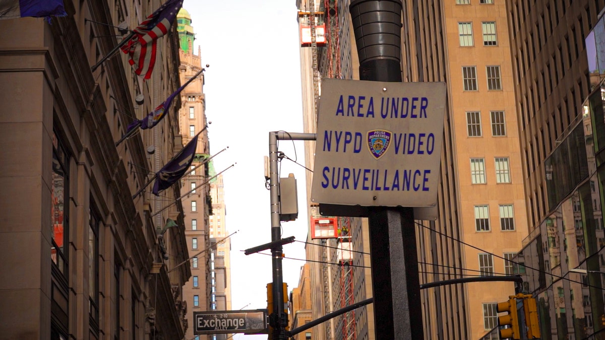 White street sign in New York City with black lettering reading, "AREA UNDER NYPD VIDEO SURVEILLANCE."