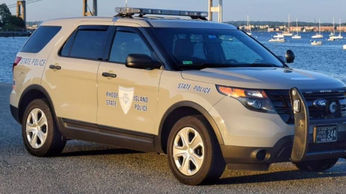 Rhode Island State Police SUV parked near a waterfront marina.